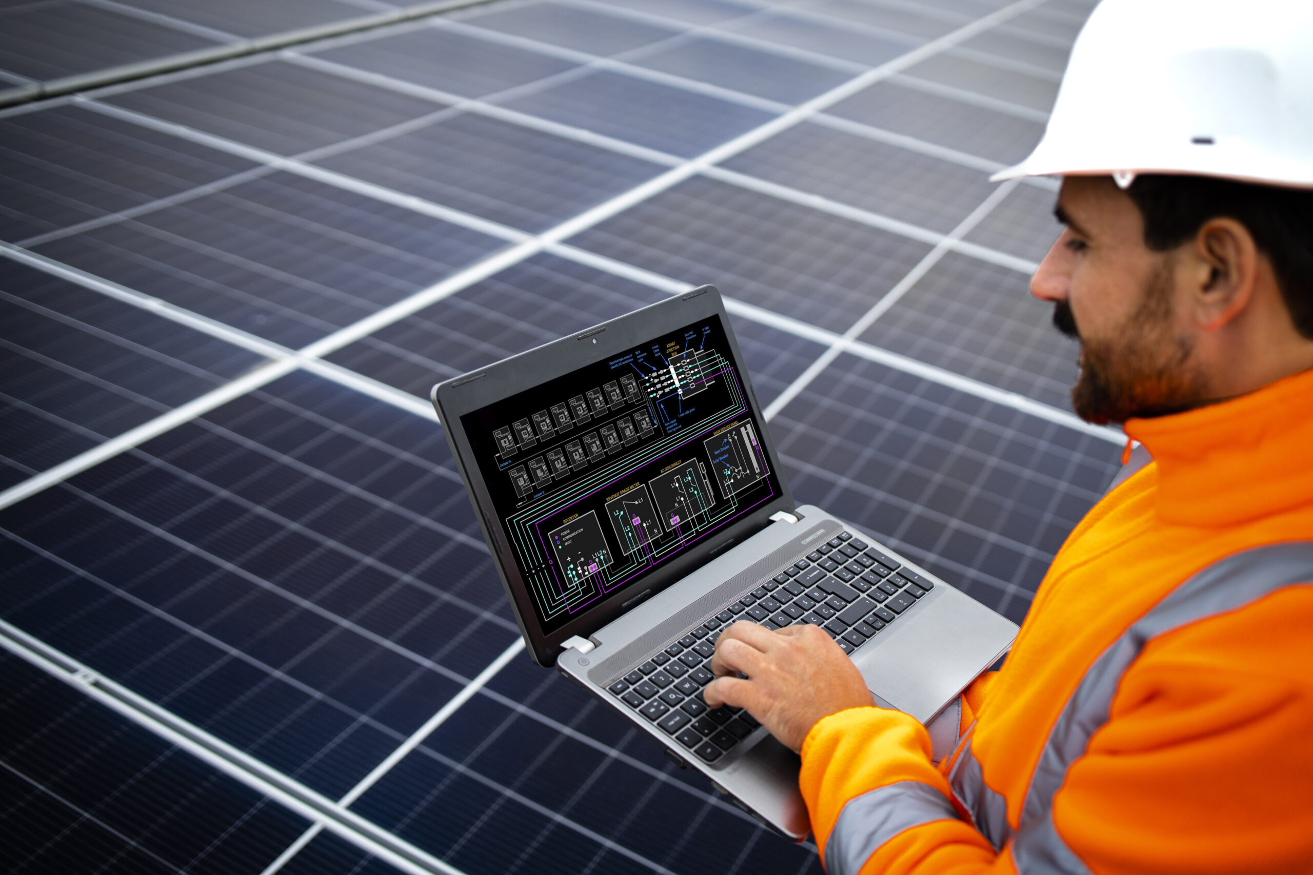 electrical engineer holding laptop computer with solar panels scheme checking productivity scaled
